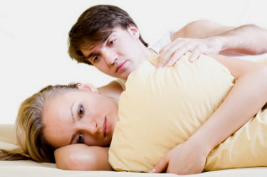 Unhappy couple in bed