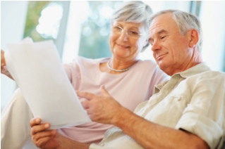 Elderly couple reading a document