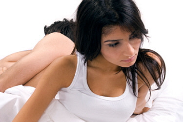 Unhappy woman in bed